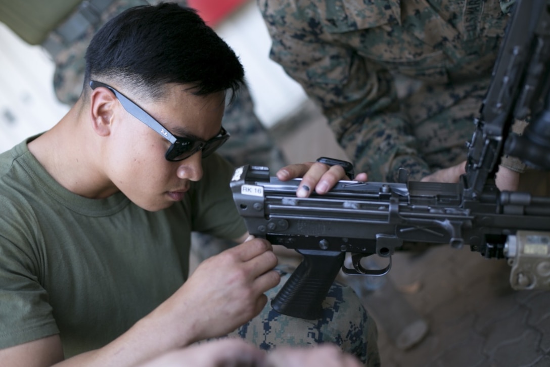 Man performing weapons maintenance.