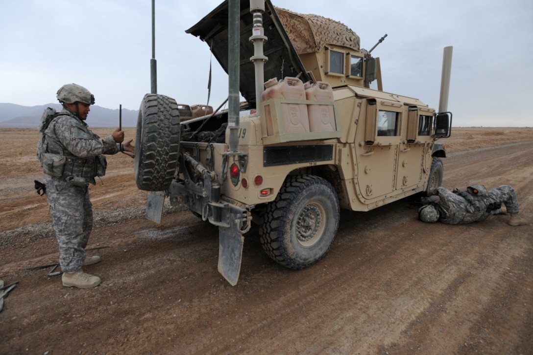 Two men working on a vehicle.