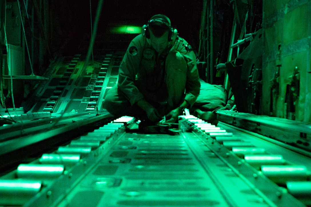 A Marine works inside an aircraft.