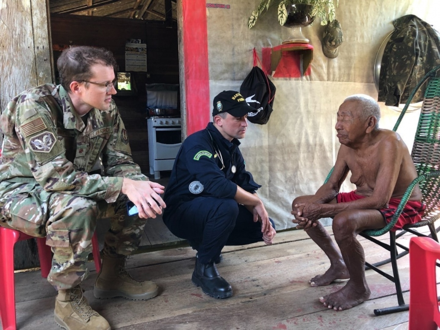 Military doctors speak to a patient.