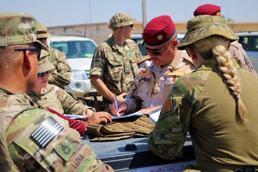 Iraqi Army Staff Brigadier General Qais Saim Jaber Abood Al 'Khafaji, 55th Brigade, 17 Division, reviews and signs documentation for an Organizational Clothing and Individual Equipment package during a Counter-Daesh Train and Equip Fund (CTEF) Divestment at Camp Taji, Iraq, June 29, 2019. The 529th Support Battalion conducts CTEF divestments to assist Iraqi Security Forces strengthen their national security. The Coalition is in Iraq by invitation of, and operates in close coordination with, the Government of Iraq.