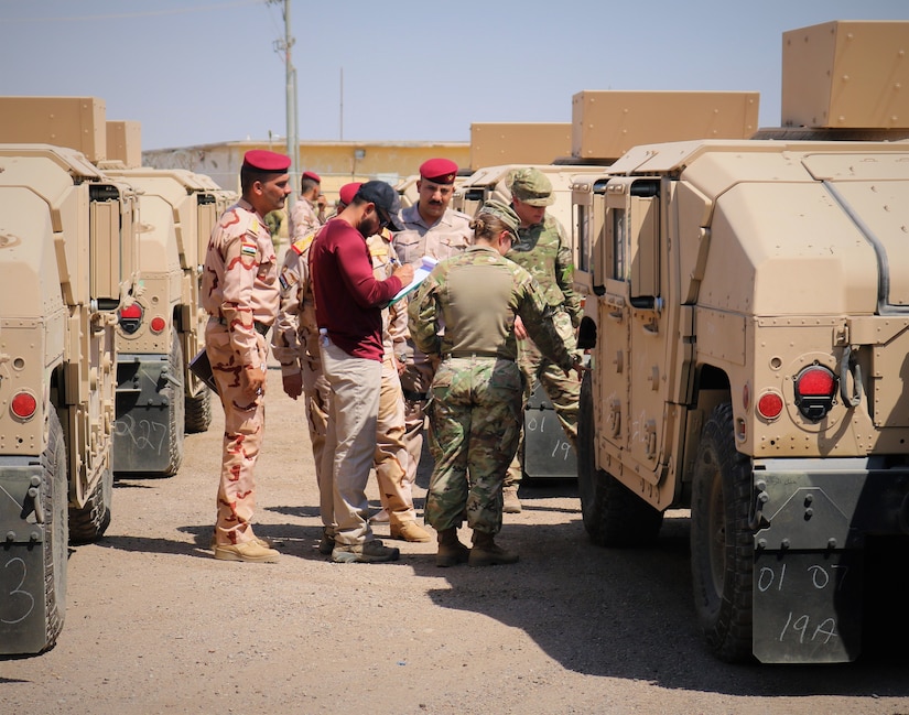 2nd 2nd Lt. Briana Nisbet, 183d Maintenance Company Counter-Daesh Train and Equip Fund (CTEF) officer in charge, verifies High Mobility Multipurpose Wheeled Vehicles with Iraqi Army Staff Brigadier General Qais Saim Jaber Abood Al 'Khafaji, 55th Brigade, 17 Division, to finalize mobility package during a CTEF Divestment at Camp Taji, Iraq, June 29, 2019. The 183d Maintenance Company, 529th Support Battalion conducts CTEF divestments to assist Iraqi Security Forces strengthen their national security. The Coalition is in Iraq by invitation of, and operates in close coordination with, the Government of Iraq.