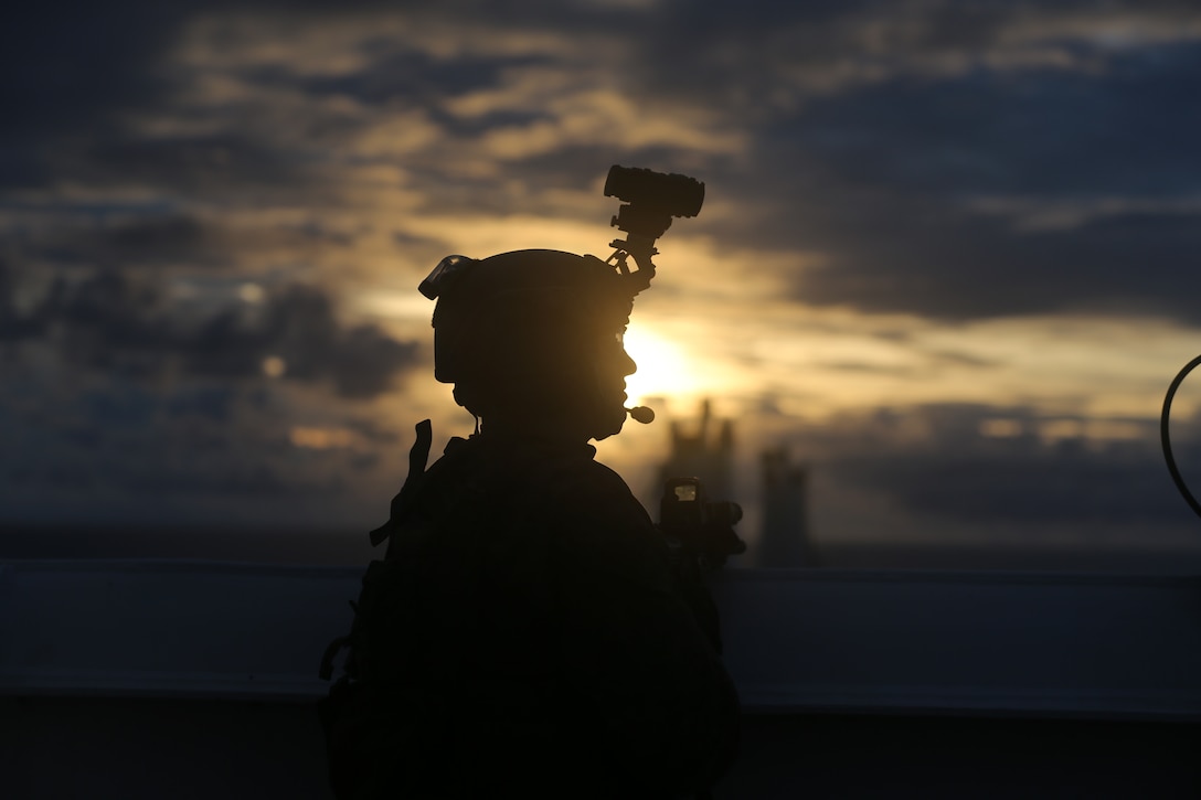 A U.S. Marine posts security during a Visit, Board, Search, and Seizure training as part of exercise HYDRACRAB, Santa Rita, Guam, Aug. 27.