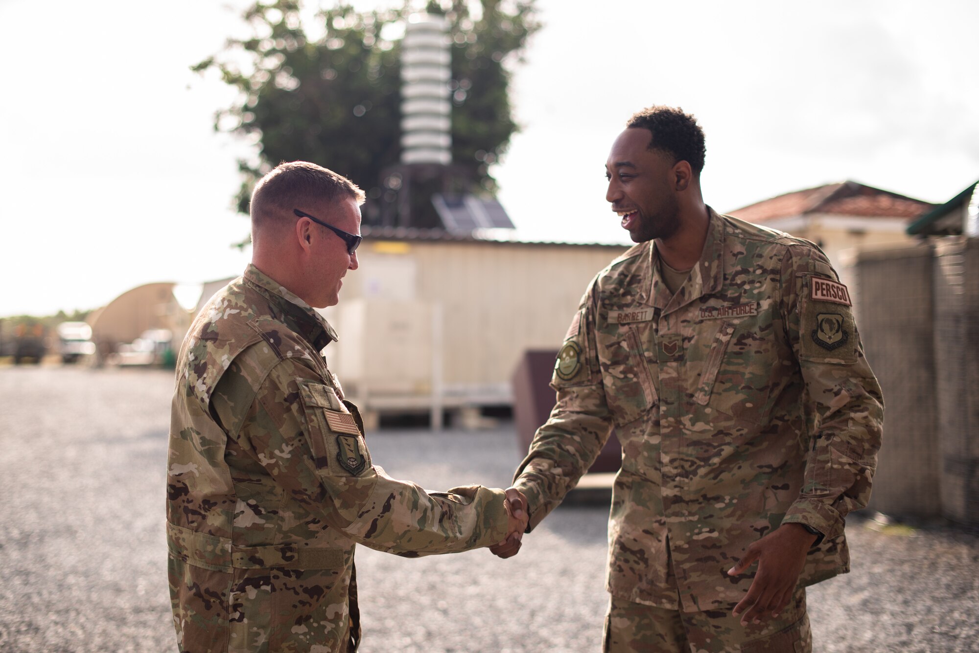 U.S. Air Force Col. Daniel C. Clayton, 435th Air Expeditionary Wing and 435th Air Ground Operations Wing commander, coins Tech. Sgt. Dominique Barrett, 475th Expeditionary Air Base Squadron personnel support for contingency operations, during an immersion tour at Camp Simba, Kenya, Aug. 30, 2019. Clayton, and Chief Master Sgt. Jeremy Unterseher, 435th AEW and 435th AGOW command chief, visited each location in the area of responsibility as part of an immersion tour. (U.S. Air Force photo by Staff Sgt. Devin Boyer)