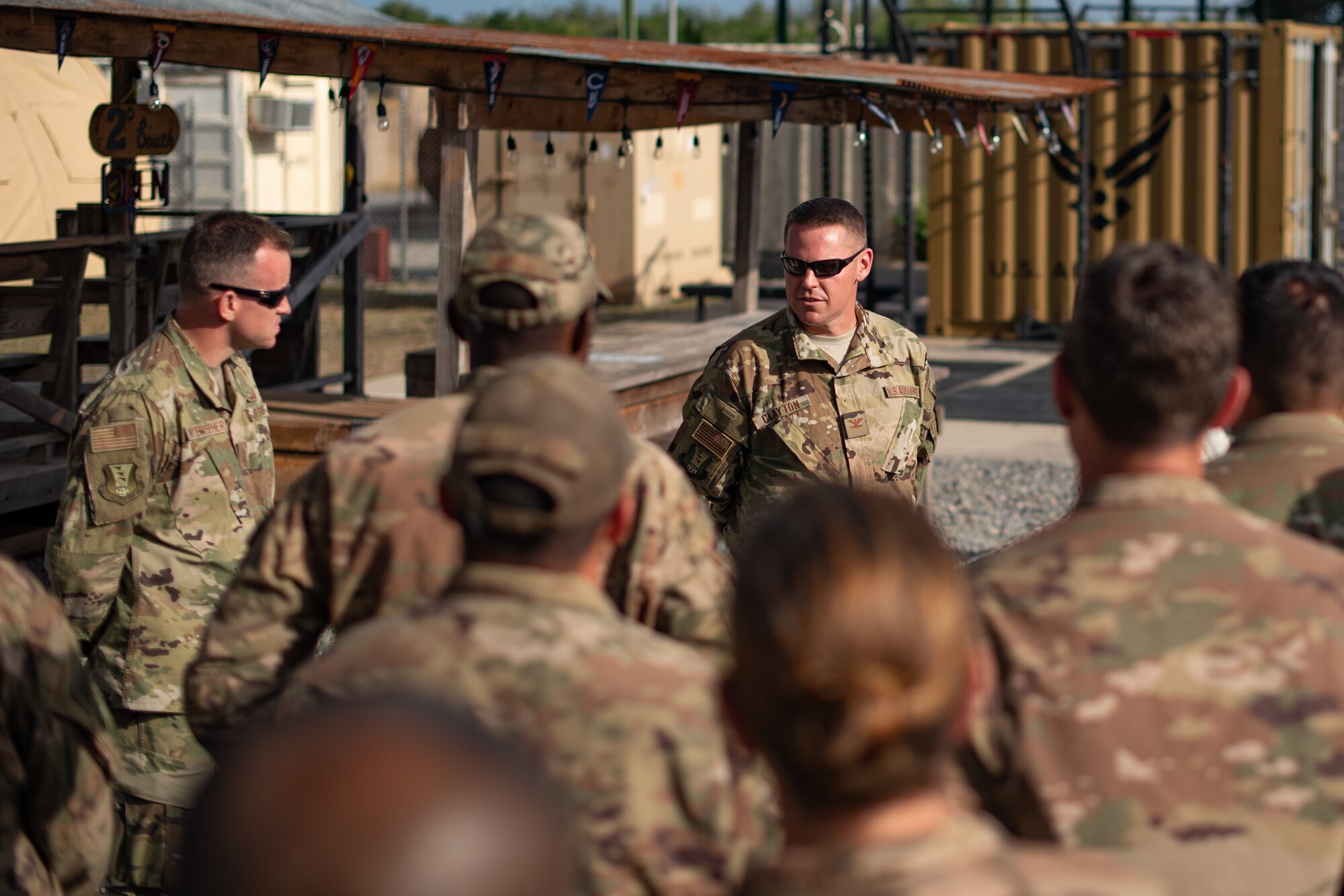 U.S. Air Force Col. Daniel C. Clayton, 435th Air Expeditionary Wing and 435th Air Ground Operations Wing commander, speaks with Airmen assigned to the 475th Expeditionary Air Base Squadron at Camp Simba, Kenya, Aug. 30, 2019. Clayton asked the Airmen what they needed to execute the mission more effectively and opened up the meeting for any questions they had. Clayton, and Chief Master Sgt. Jeremy Unterseher, 435th AEW and 435th AGOW command chief, visited each location in the area of responsibility as part of an immersion tour. (U.S. Air Force photo by Staff Sgt. Devin Boyer)
