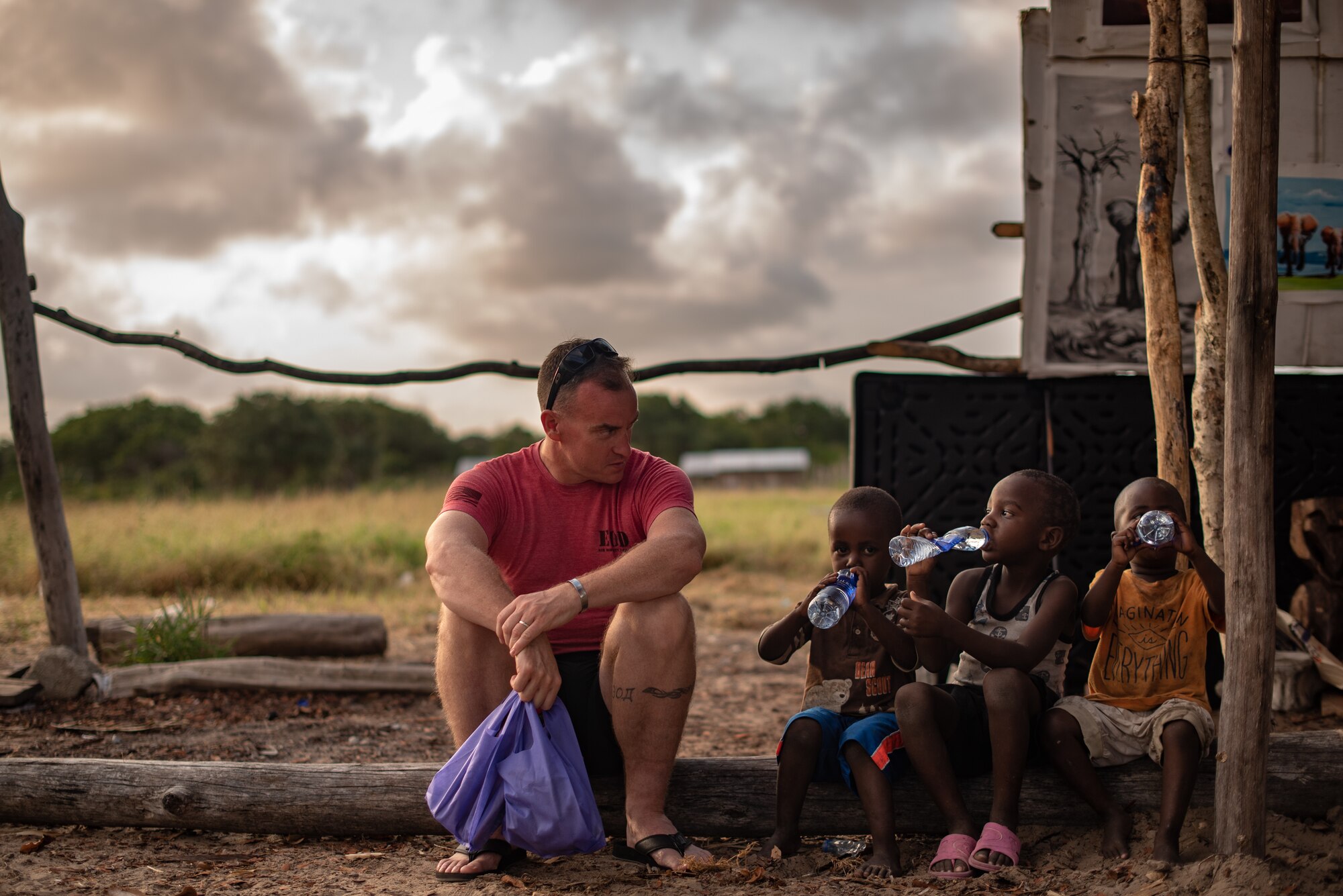 U.S. Air Force Chief Master Sgt. Jeremy Unterseher, 435th Air Expeditionary Wing and 435th Air Ground Operations Wing command chief, talks to children at a village near Camp Simba, Kenya, Aug. 30, 2019. Unterseher and Col. Daniel C. Clayton, 435th AEW and 435th AGOW commander, visited the village as part of an immersion tour for the 435th AEW. (U.S. Air Force photo by Staff Sgt. Devin Boyer)