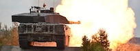 British soldiers with the Queen’s Royal Hussars fire a Challenger II main battle tank during the defensive operations lane as part of the Strong Europe Tank Challenge, June 7, 2018.