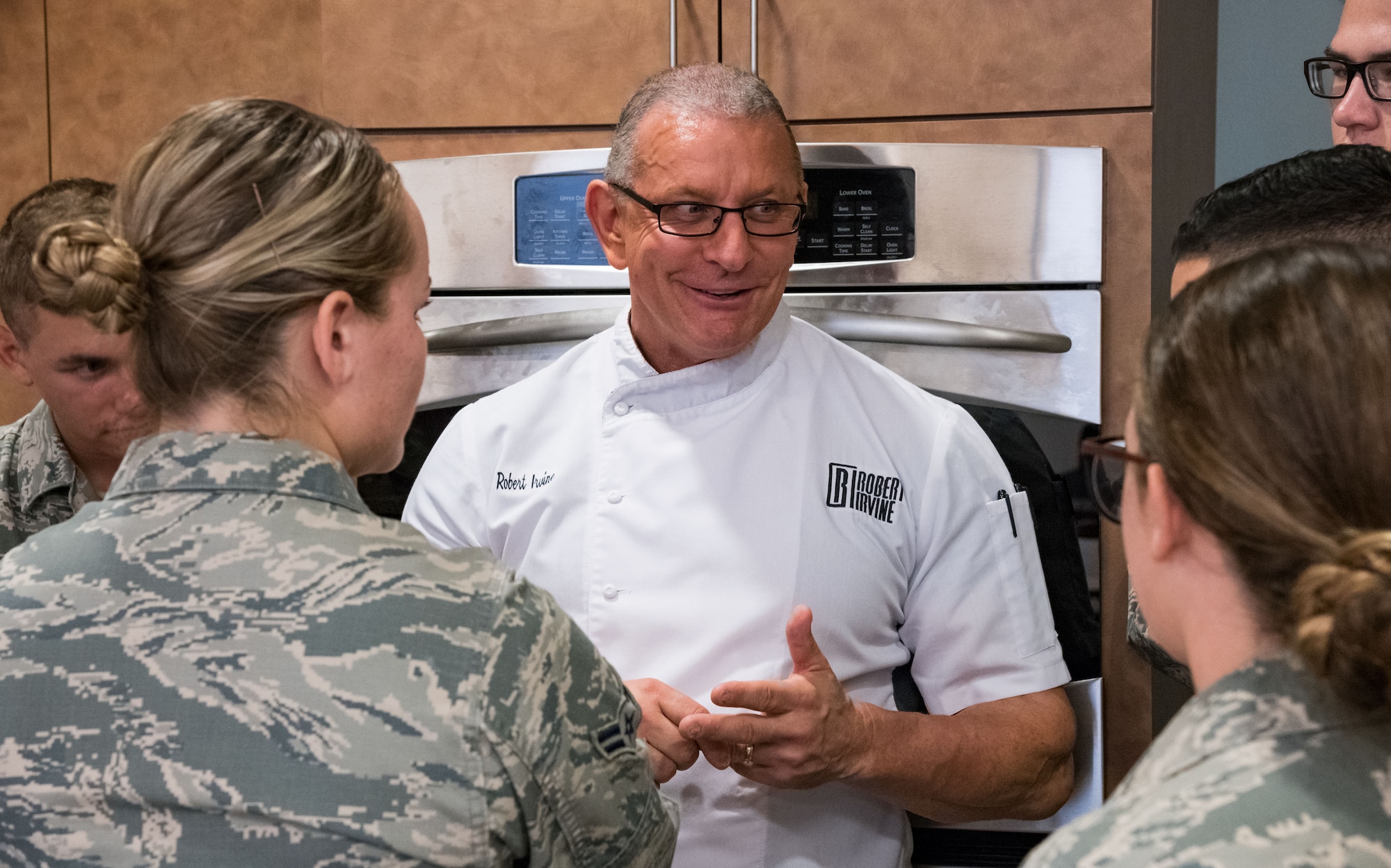 Chef Robert Irvine talks with Airmen at the end of Dorm to Gourm, Aug. 27, 2019, at Dover Air Force Base, Del. Irvine gave his views about career and life choices. (U.S. Air Force photo by Roland Balik)