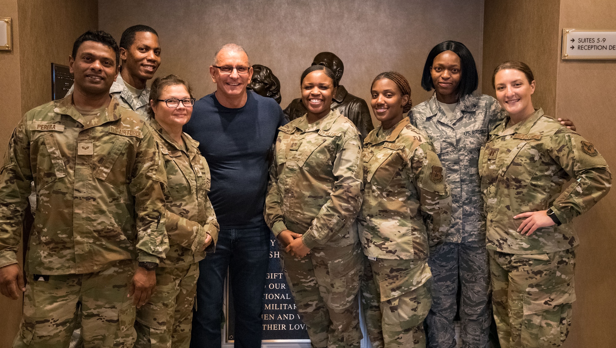 Chef Robert Irvine and Air Force Mortuary Affairs Operations personnel pose for a photo, Aug. 27, 2019, at the Fisher House on Dover Air Force Base, Del. Irvine toured the Fisher House and was briefed on its history. (U.S. Air Force photo by Roland Balik)