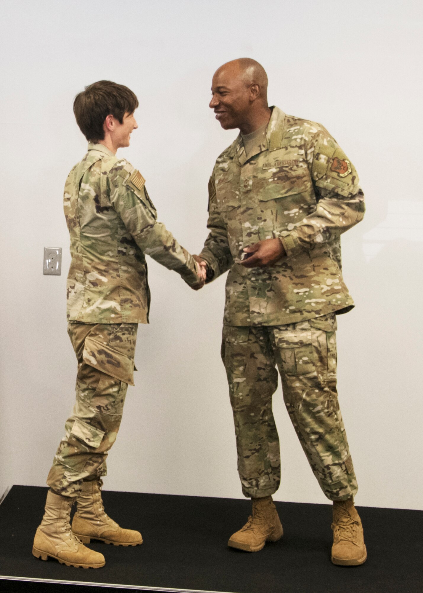 Chief Master Sergeant of the Air Force Kaleth O. Wright coins Master Sgt. Megan Kuszewski from the 459th Operations Support Squadron during an all-call Aug. 12, 2019, at Joint Base Andrews, Md. Wright recognized five Airmen from across the wing for their outstanding work performance and accomplishments. (U.S. Air Force photo by Staff Sgt. Cierra Presentado/Released)