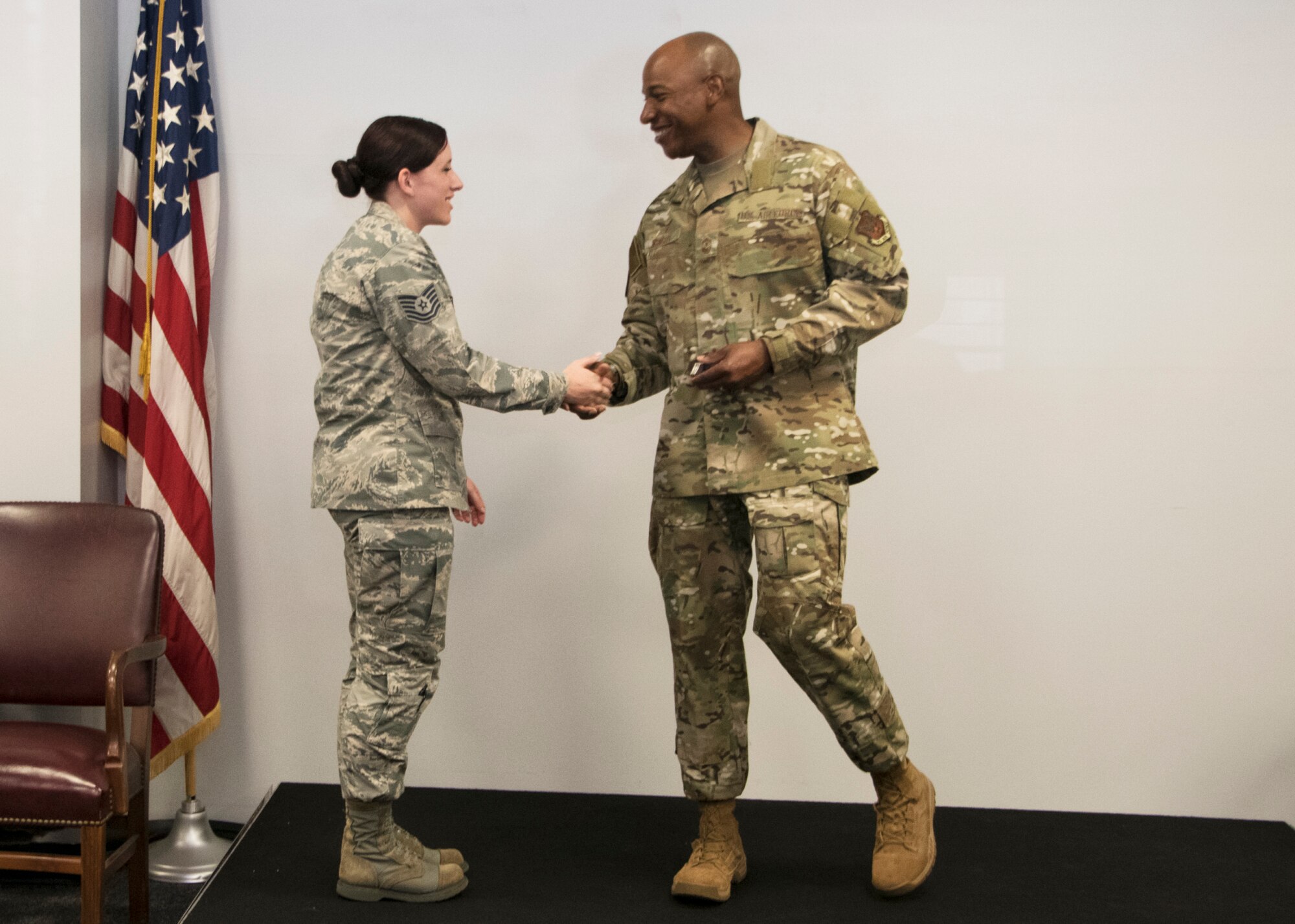 Chief Master Sergeant of the Air Force Kaleth O. Wright coins Tech Sgt. Shelby Zimmerman, 459th Logistic Readiness Squadron during an all-call Aug. 12, 2019, at Joint Base Andrews, Md. Wright recognized five Airmen from across the wing for their outstanding work performance and accomplishments. (U.S. Air Force photo by Staff Sgt. Cierra Presentado/Released)