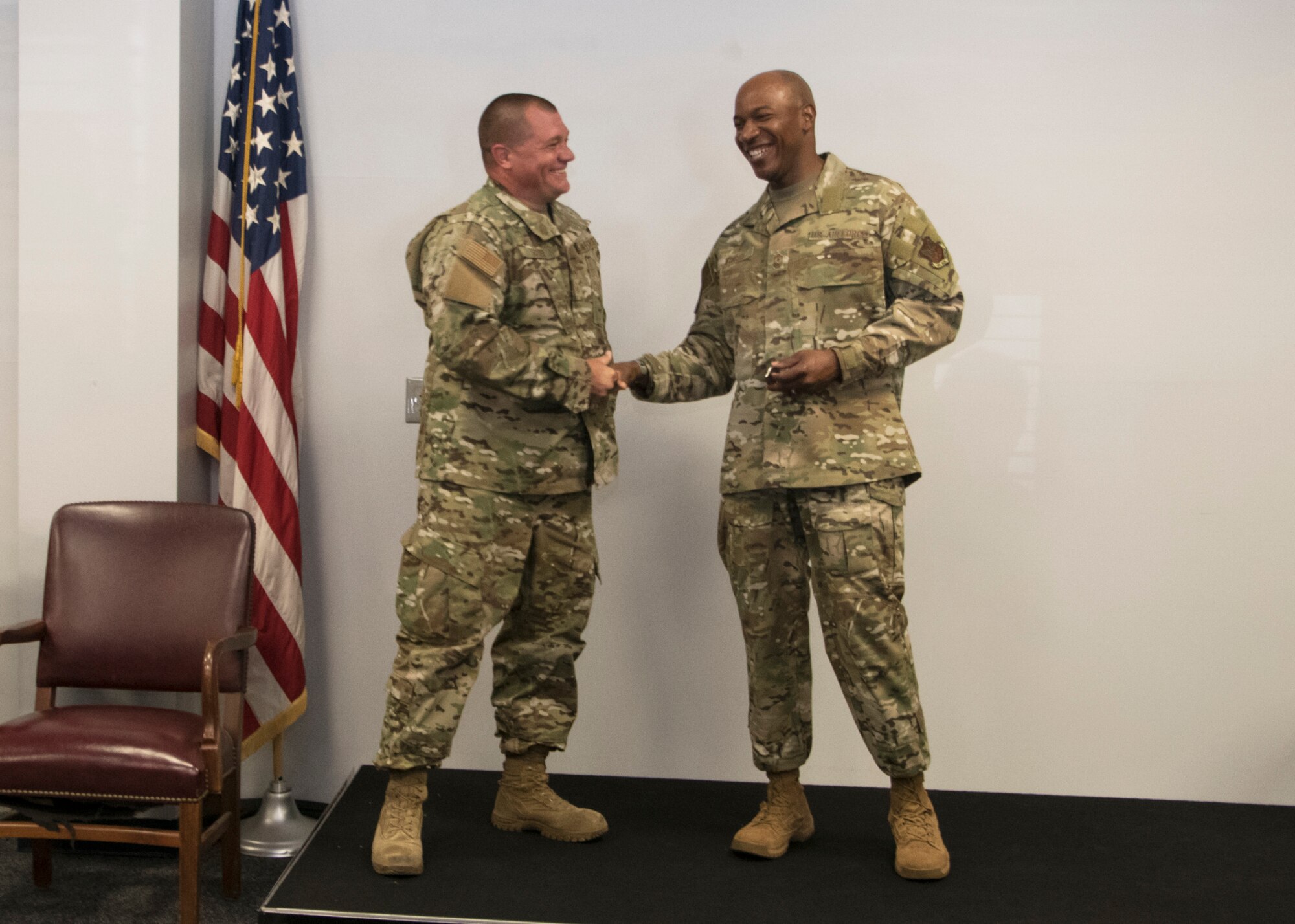 Chief Master Sergeant of the Air Force Kaleth O. Wright coins Master Sgt. Randy Suter from the 459th Aircraft Maintenance Squadron, during an all-call Aug. 12, 2019, at Joint Base Andrews, Md. Wright recognized five Airmen from across the wing for their outstanding work performance and accomplishments. (U.S. Air Force photo by Staff Sgt. Cierra Presentado/Released)