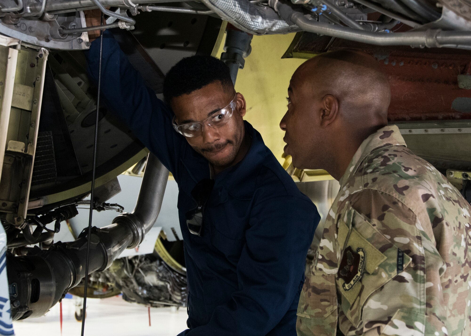 Chief Master Sergeant of the Air Force Kaleth O. Wright looks on as a member of the 459th Maintenance Group performs maintenance on a KC-135 Stratotanker during a visit to the wing Aug. 12, 2019, at Joint Base Andrews, Md. During his visit, Wright was shown a KC-135 Stratotanker by members of the 459th MXG prior to holding an all call where he addressed issues happening in today’s Air Force. (U.S. Air Force photo by Staff Sgt. Cierra Presentado/Released)