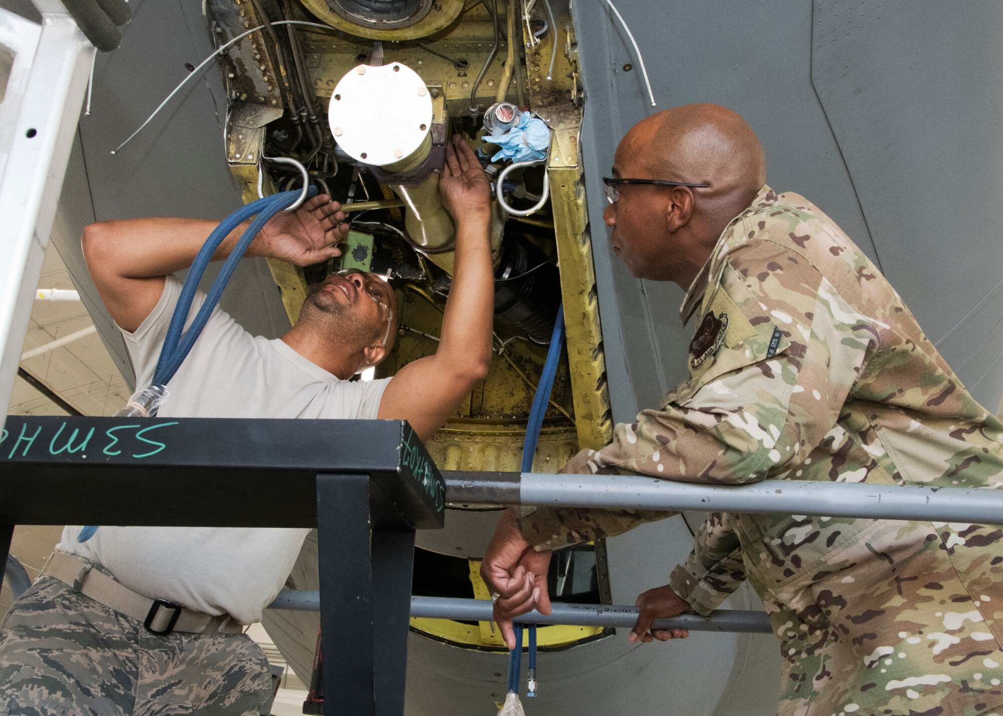 Chief Master Sergeant of the Air Force Kaleth O. Wright looks on as a member of the 459th Maintenance Group performs maintenance on a KC-135 Stratotanker during a visit to the wing, Aug. 12, 2019, at Joint Base Andrews, Md. During his visit, Wright was shown a KC-135 Stratotanker by members of the 459th Aircraft Maintenance prior to holding an all call where he addressed issues happening in today’s Air Force. (U.S. Air Force photo by Staff Sgt. Cierra Presentado/Released)