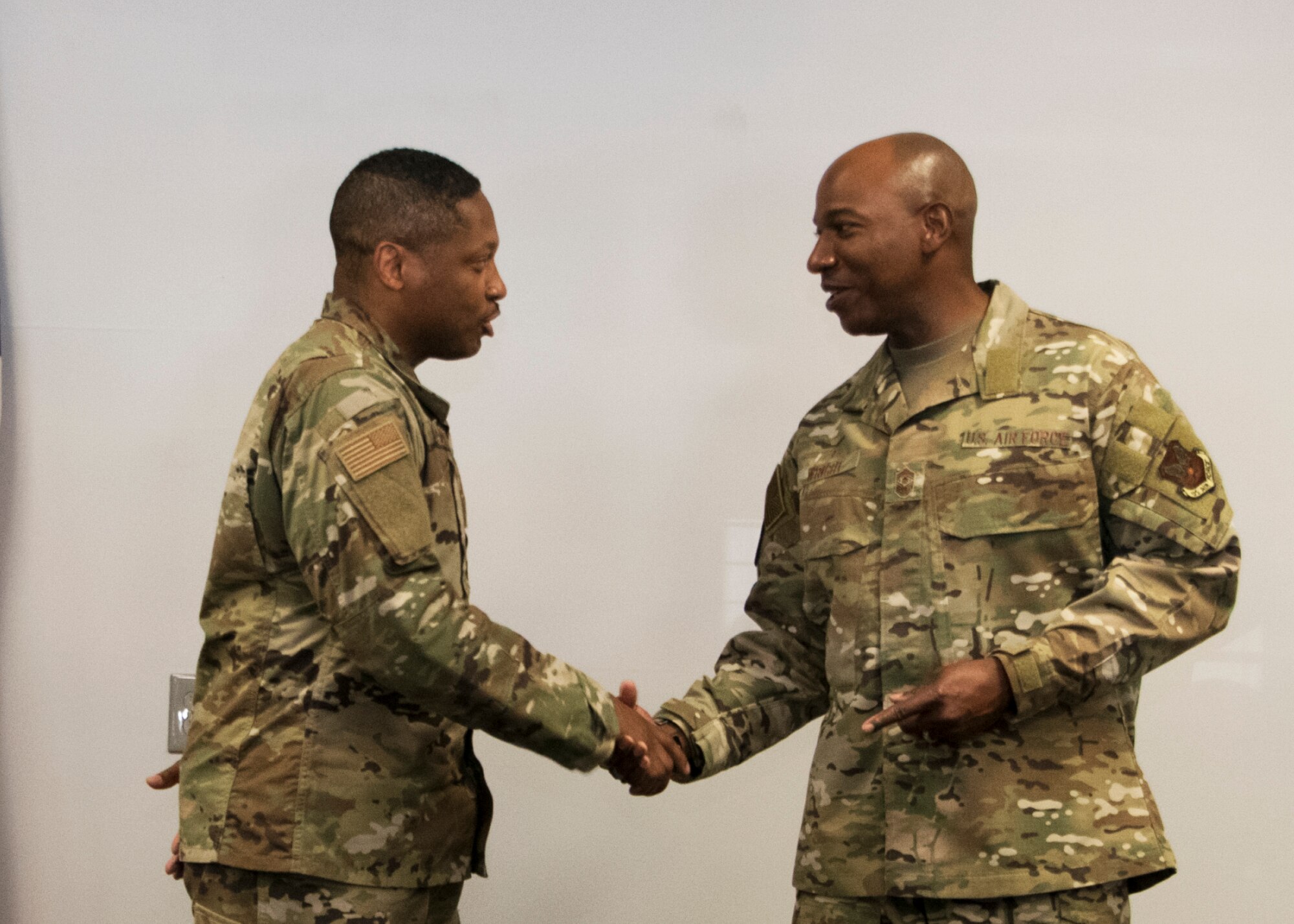 Chief Master Sergeant of the Air Force Kaleth O. Wright coins Master Sgt. Kenyatta Stevenson from the 459th Force Support Squadron, during an all-call Aug. 12, 2019, at Joint Base Andrews, Md. Wright recognized five Airmen from across the wing for their outstanding work performance and accomplishments. (U.S. Air Force photo by Staff Sgt. Cierra Presentado/Released)