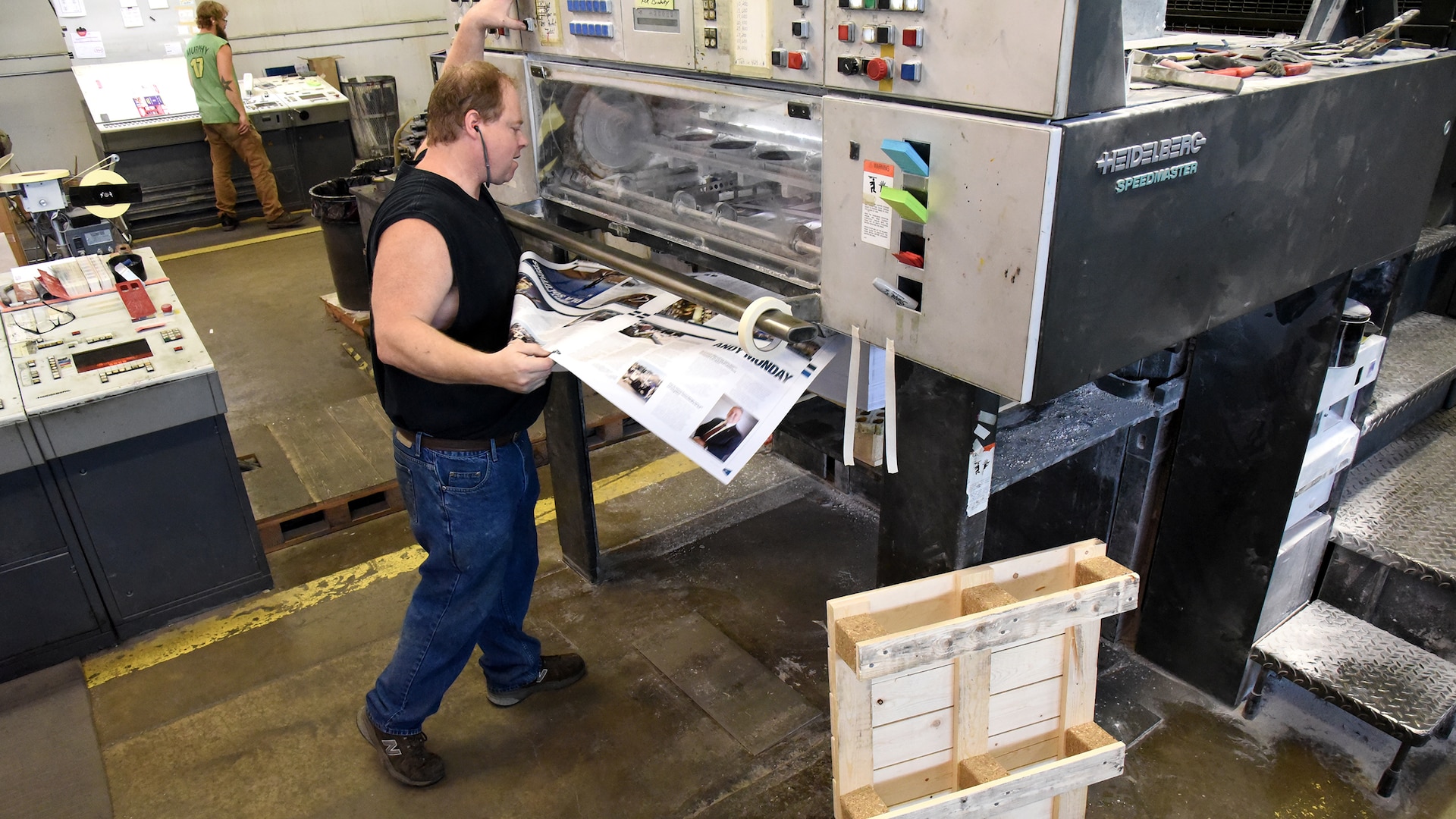 Press Operator Everett E. (Skip) Craig Jr. of KB Offset Printing Inc., in State College, Pennsylvania, pulls a page off the press to randomly check print quality of DLA’s Loglines magazine Aug. 26. Photo by Phil Prater