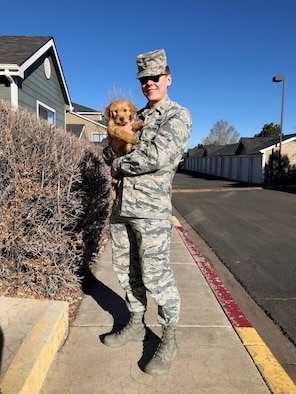 2nd Lt. Justin Davidson-Beebe, 21st Space Wing public affairs officer, poses for a photo with his dog Butters March 20, 2019 at Peterson Air Force Base, Colorado. He said that Butters and the other dogs he’s had through his life help him maintain his resilience because of their innate enthusiasm. (U.S. Air Force courtesy photo)