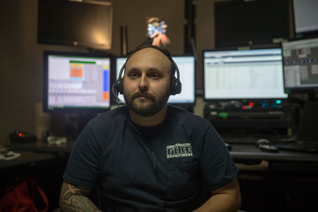 Michael Fila, an emergency dispatcher on Marine Corps Base Camp Pendleton, poses for a photo in the dispatch center on Camp Pendleton, California, Aug. 26, 2019. Fila was medically separated from the Marine Corps in 2014 due to being diagnosed with multiple sclerosis. He continues to work on Camp Pendleton to give back to the Corps and maintain the brotherhood he feels toward his fellow Marines. (U.S. Marine Corps photo by Lance Cpl. Andrew Cortez)