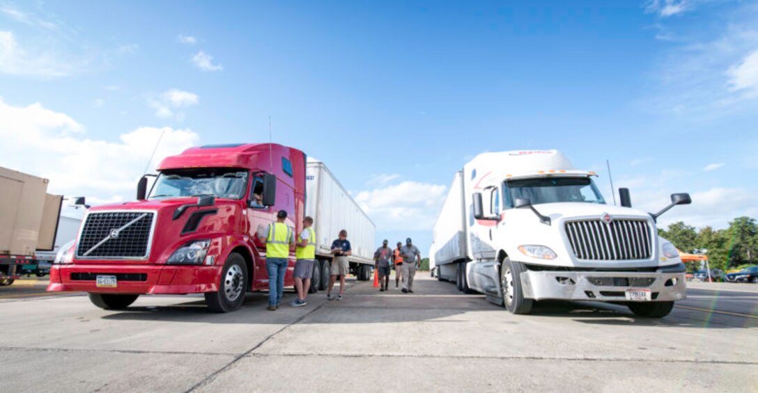 Anthony Jones, Ryan Sisson and Derek Smith, center, members of DLA Distribution's expeditionary team, work with Federal Emergency Management Agency employees, left, at a FEMA Incident Staging Base at Maxwell Air Force Base in Montgomery, Alabama, Sept. 2 to stage trucks arriving with commercial meals in preparation for Hurricane Dorian support efforts. Courtesy photo