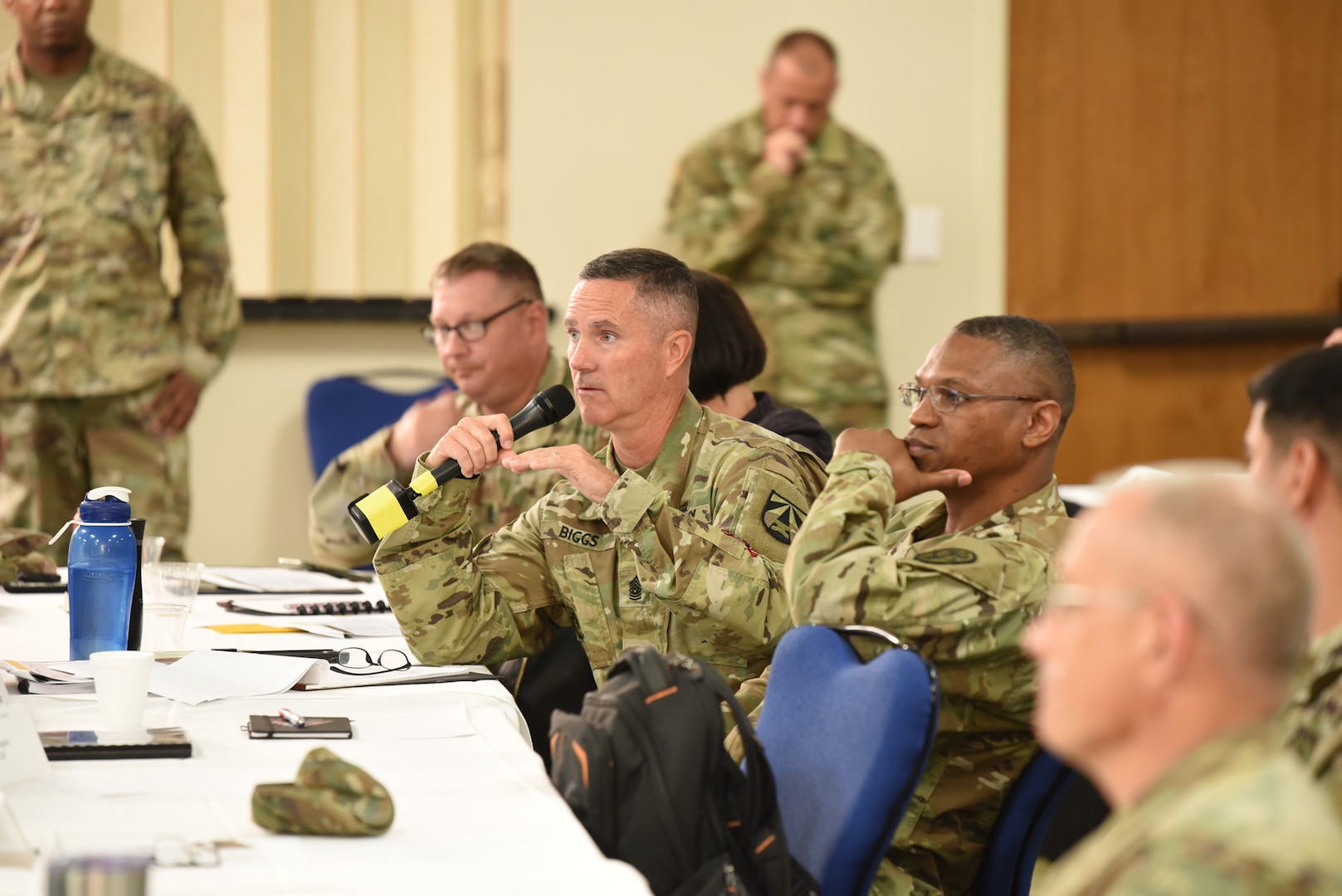 Command Sgt. Maj. Paul Biggs, Future and Concepts Center, U.S. Army Futures Command (center left), asking a question while Command Sgt. Maj. Michael Gragg, U.S. Army Medical Command, looks on.