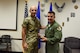 U.S. Air Force Gen. Mike Holmes, commander of Air Combat Command, presents U.S. Air Force Maj. Kyle Waite, Det. 1, 563rd Operations Support Squadron commander, with a Cheney award at Davis-Monthan Air Force Base, Arizona, Aug. 21, 2019. Waite was the mission commander and flight lead for two challenging and dynamic civil search and rescue missions, which ultimately saved four lives. (U.S. Air Force photo by Senior Airman Mya M. Crosby)