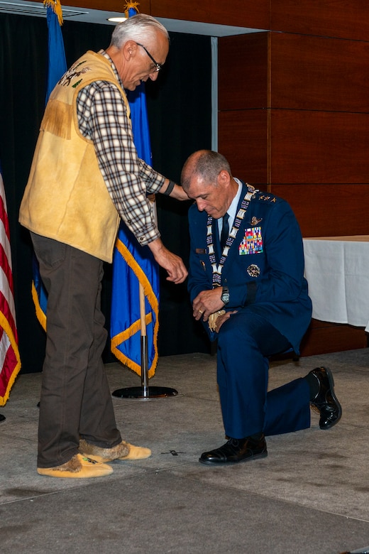Will Mayo, Alaska Federation of Natives co-chair and Tanana Chiefs Conference member, presents a chief’s necklace to U.S. Air Force Lt. Gen. Thomas Bussiere, commander, Alaskan North American Aerospace Defense Command Region, North American Aerospace Defense Command; commander, Alaskan Command, U.S. Northern Command; and commander, 11th Air Force, Pacific Air Forces, during an Alaska Native naming ceremony on Joint Base Elmendorf-Richardson, Alaska, Aug. 28, 2019. The AFN hosted the event honoring Bussiere for his service and his active engagement with the Alaskan Native community during his tenure in Alaska. The naming ceremony is based on the traditional belief that a person’s name is the type of soul they possess. The ceremony showcased the bond between the Alaska Native community and the military in Alaska.