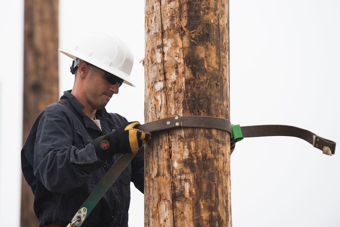 Staff Sgt. Lonnie Elliott, 30th Civil Engineer Squadron electrician, climbs a power pole during pole-top rescue training Aug. 23, 2019, at Vandenberg Air Force Base, Calif. The Airmen assigned to the 30th CES electrical shop practice emergency life-saving maneuvers to retrieve members who may become injured while working on a power pole. For these Airmen, pole-top rescue is an annual training requirement and is incorporated into their weekly training time. (U.S. Air Force photo by Hanah Abercrombie)