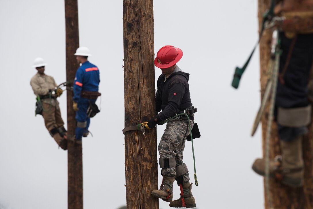 Airmen assigned to 30th Civil Engineer Squadron prepare for pole-top rescue training Aug. 23, 2019, at Vandenberg Air Force Base, Calif. During their weekly pole-top rescue training, the Airmen practice emergency life-saving maneuvers to retrieve members who may become injured while working on a power pole. The Airmen also practice confined space rescue and bucket truck rescue to ensure each Airmen is prepared during an emergency situation. (U.S. Air Force photo by Hanah Abercrombie)