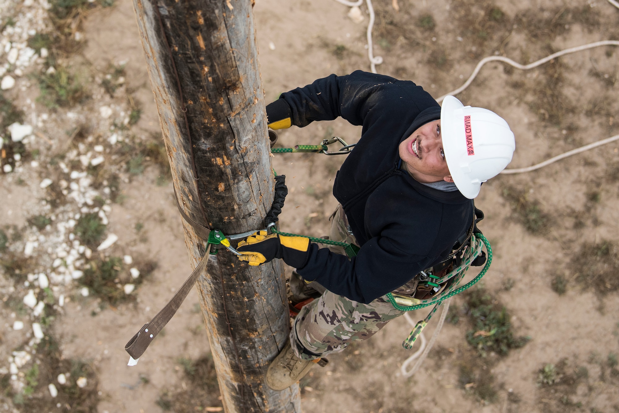 Senior Airman Tyler Maxwell, 30th Civil Engineer Squadron electrician, climbs a power pole during a pole-top rescue training Aug. 23, 2019, at Vandenberg Air Force Base, Calif. While working pole-top, there are many risks service members could encounter such as electrocution and burns, making it imperative that proper rescue procedures are in place. For Airmen assigned to the 30th CES electrical shop, pole-top rescue is an annual training requirement and is incorporated into their weekly training time.   (U.S. Air Force photo by Hanah Abercrombie)