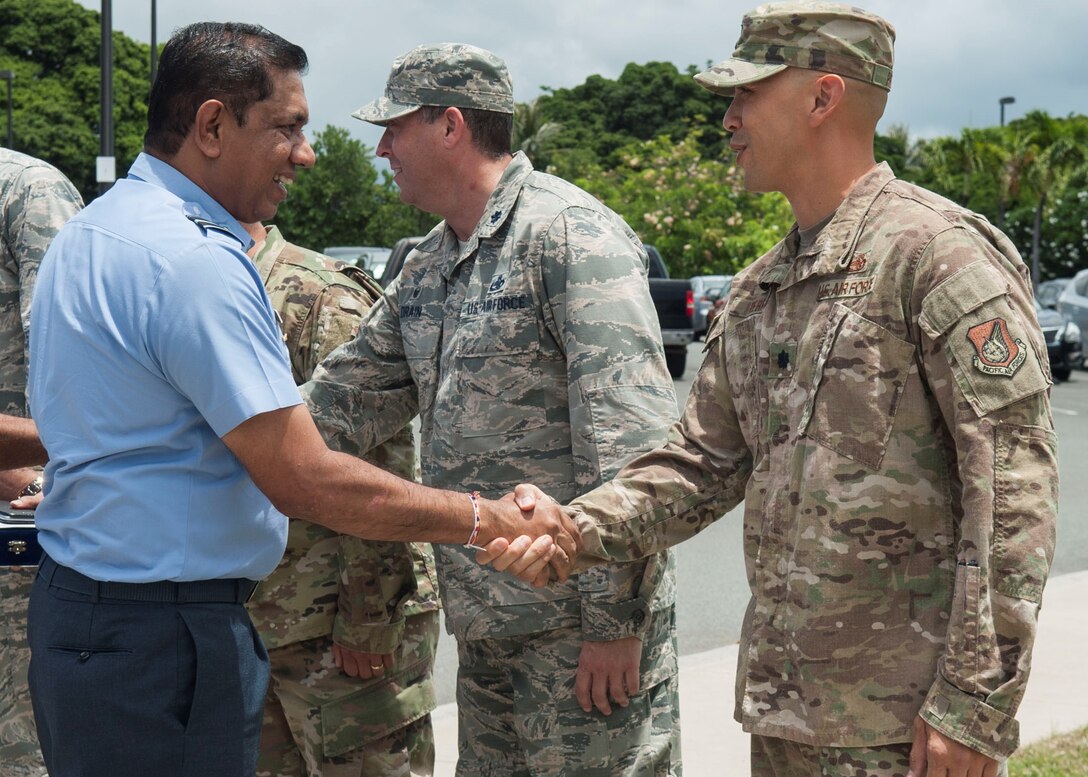 Air Vice Marshal Sudarshana Pathirana, Sri Lanka air force chief of staff, is greeted by members of the 15th Maintenance Group at Joint Base Pearl Harbor-Hickam, Hawaii, Aug. 20, 2019. During the four-day visit, SLAF and U.S. Air Force senior leaders engaged in three different working groups; humanitarian assistance and disaster relief, air and maritime domain awareness, and force development. (U.S. Air Force photo by Staff Sgt. Mikaley Kline)