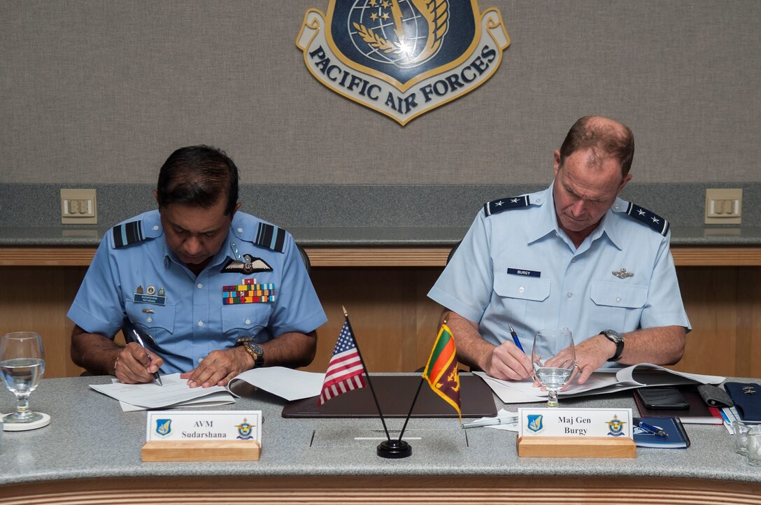 Air Vice Marshal Sudarshana Pathirana, Sri Lanka air force chief of staff, and Maj. Gen. David Burgy, Air National Guard assistant to the Pacific Air Forces commander, sign documents during the Airman-to-Airman talks at Joint Base Pearl Harbor-Hickam, Hawaii, Aug. 22, 2019. The multi-day event marked the third A2A talks between the United States and Sri Lanka. (U.S. Air Force photo by Staff Sgt. Mikaley Kline)