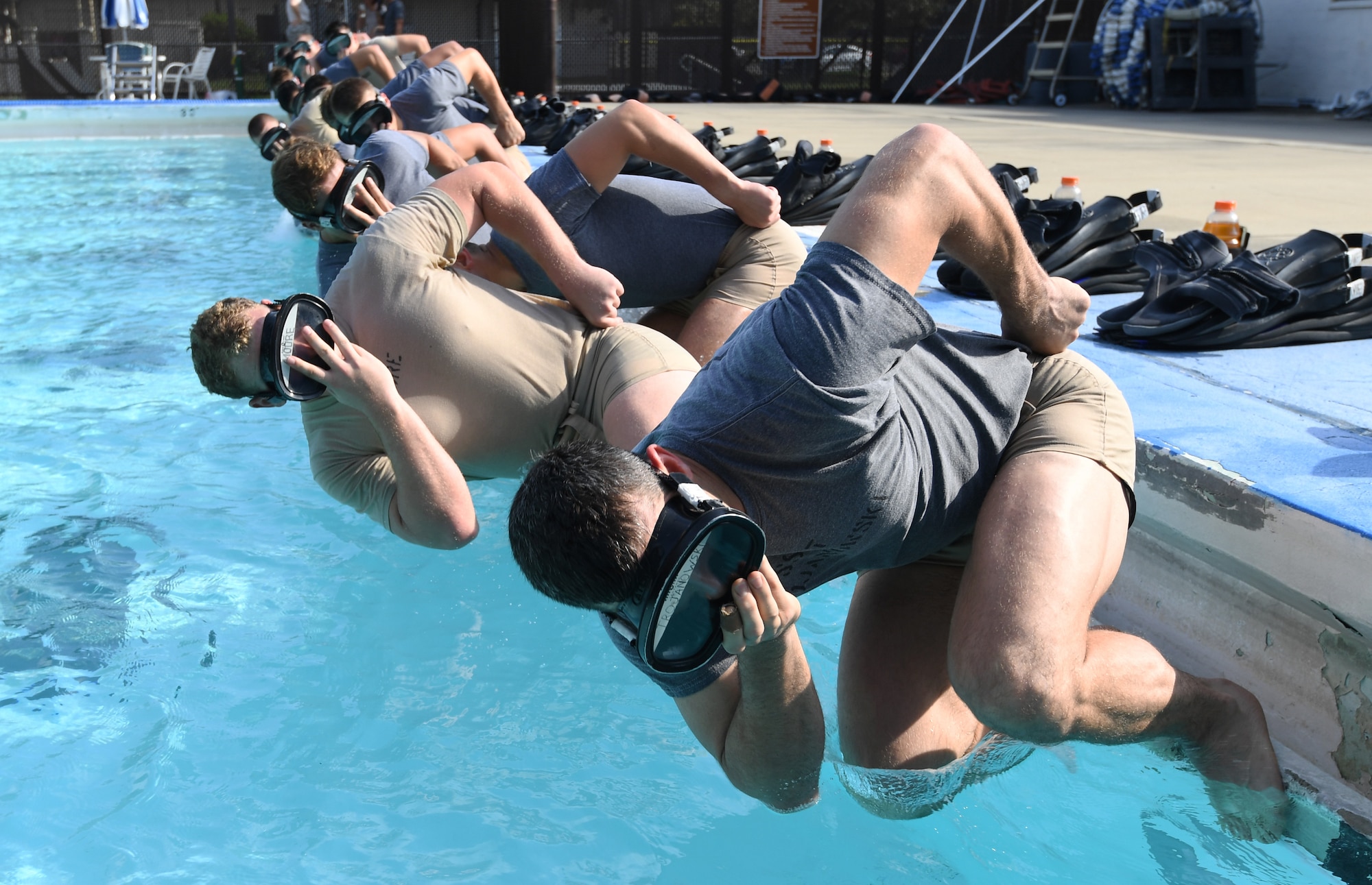 Special Warfare trainees from the 352nd Special Warfare Training Squadron participate in a memorial physical training session at the Triangle Pool on Keesler Air Force Base, Mississippi, Aug. 9, 2019. The PT event was in memory of U.S. Air Force Staff Sgt. Andrew Harvell, combat controller, who was killed in action on Aug. 6, 2011. Special Warfare trainees also attend courses in the 334th and 335th Training Squadrons. (U.S. Air Force photo by Kemberly Groue)