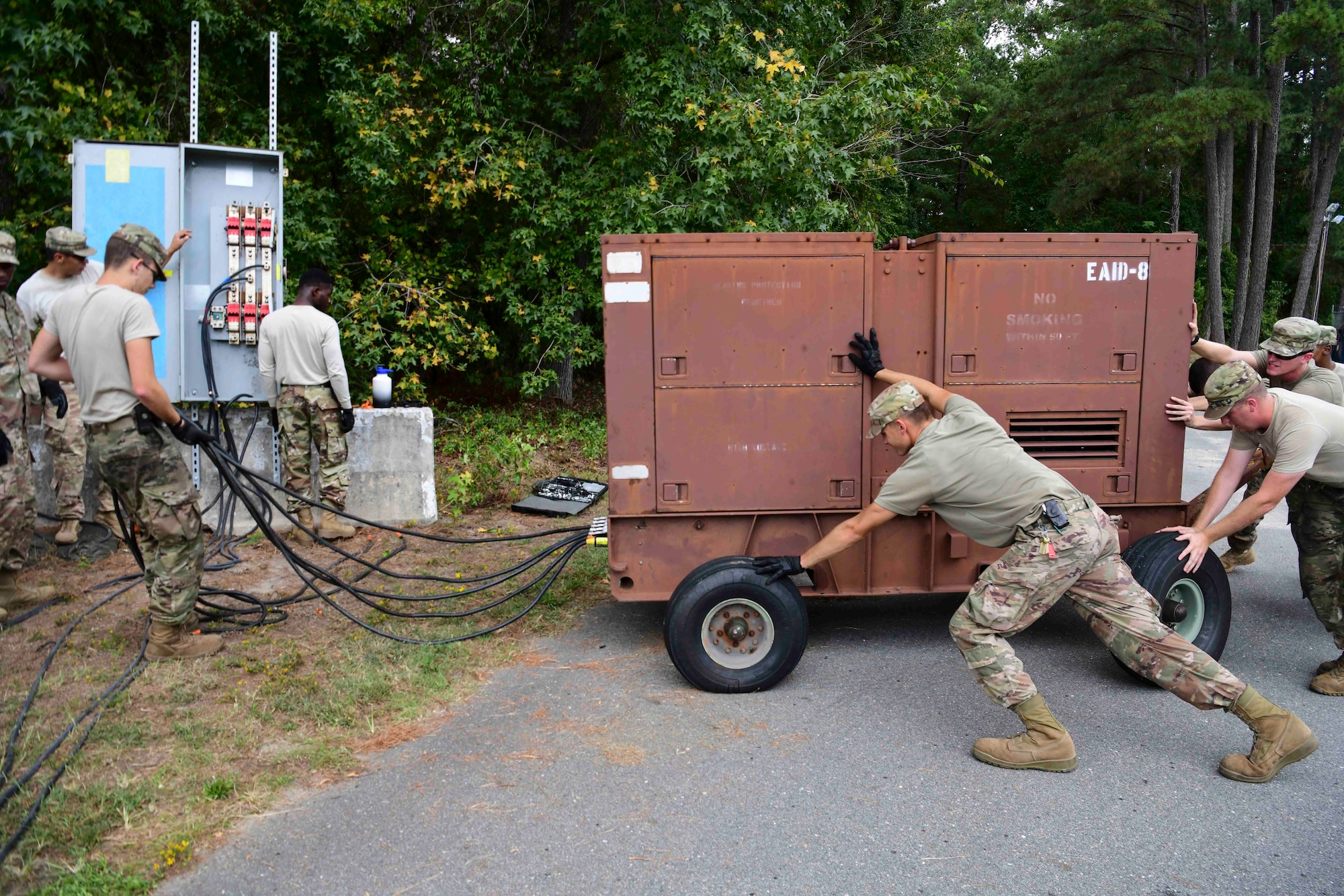 Airmen from the 4th Electrical Engineer Squadron and 567th Red Horse Squadron set up a generator for the military working dog kennels before Hurricane Dorian, Sept. 4, 2019, at Seymour Johnson Air Force Base, North Carolina. The 4th CES, to include equipment operators, electricians, plumbers, structural craftsman, heating, ventilation and air conditioning, and production technicians, are providing 24-hour response and recovery operations during and following Hurricane Dorian. (U.S. Air Force photo by Senior Airman Boyton)