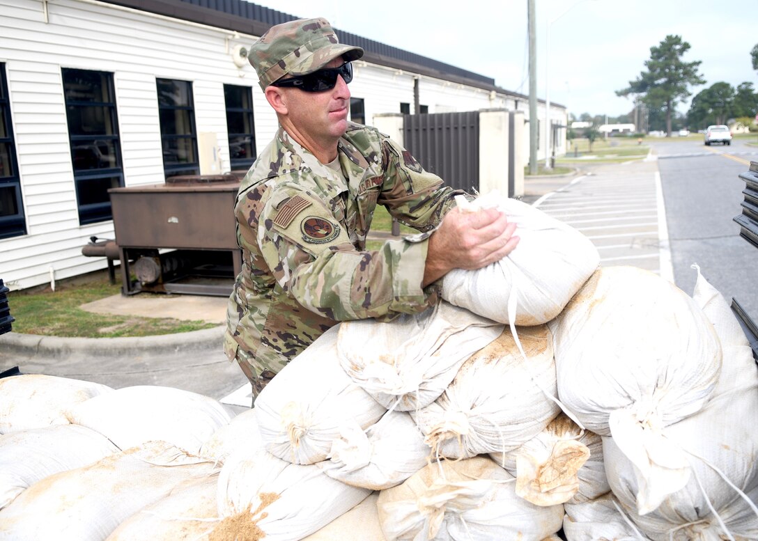 Seymour Johnson Air Force Base, N.C. — Tech Sgt Thomas Hartt, 4th Civil Engineer Squadron pavement and production specialist, unloads sand bags from a truck Sept. 4, 2019, at Seymour Johnson Air Force Base, North Carolina. Airmen and their families assigned to Seymour Johnson AFB prepared the installation for possible hurricane winds associated with Hurricane Dorian. (U.S. Air Force photo by Staff Sgt. Michael Charles)
