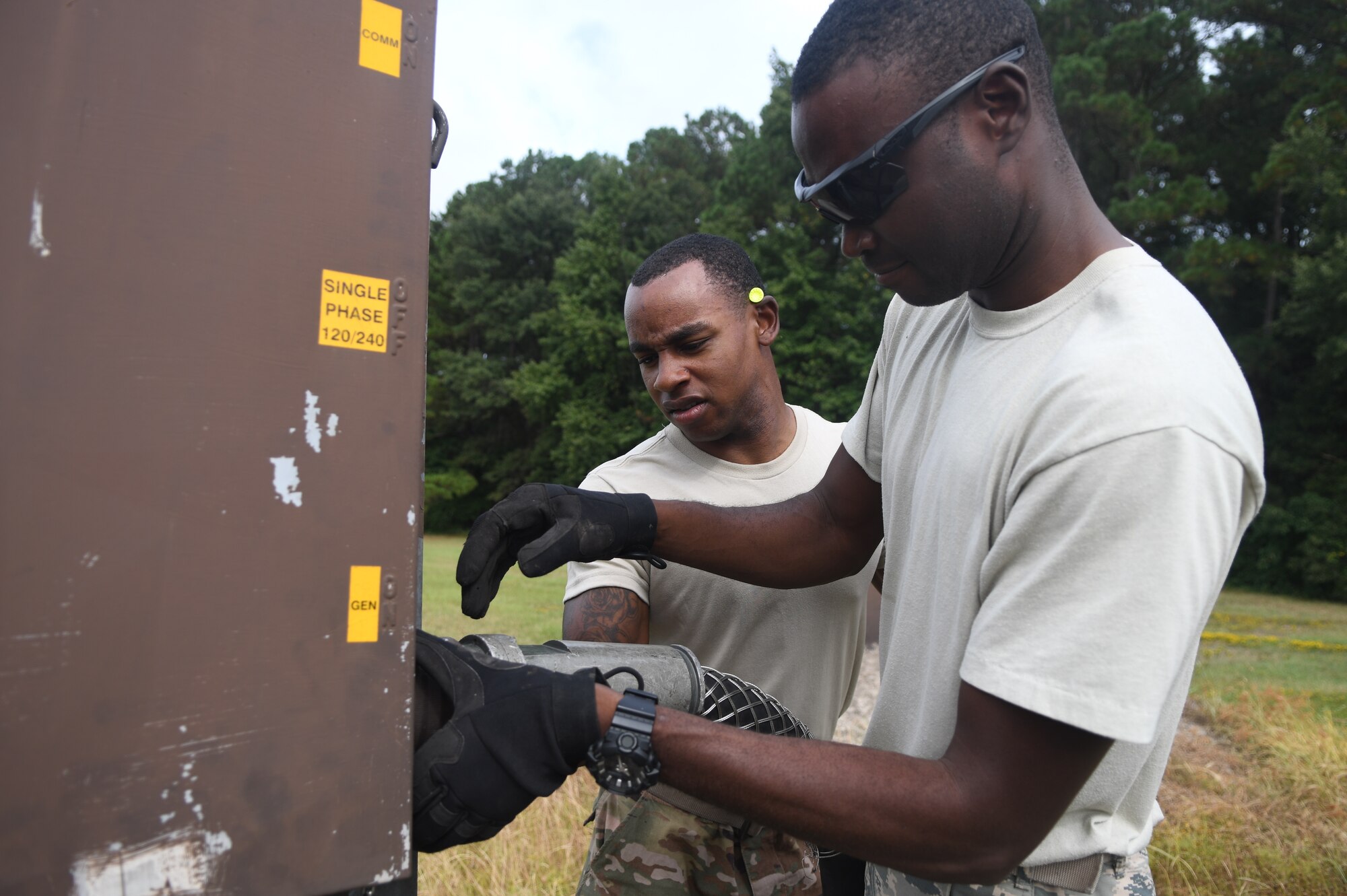 Seymour Johnson Air Force Base, N.C. — Staff. Sgt. Moctar Sana and Senior Airman Courtney Wilking, 4th Civil Engineer Squadron pavement and production specialists, connect a generator to the flightline’s barrier control system Sept. 4, 2019, at Seymour Johnson Air Force Base, North Carolina. The 4th CES, to include equipment operators, electricians, plumbers, structural craftsman, heating, ventilation and air conditioning, and production technicians, are providing 24-hour response and recovery operations during and following Hurricane Dorian. (U.S. Air Force photo by Staff Sgt. Michael Charles)
