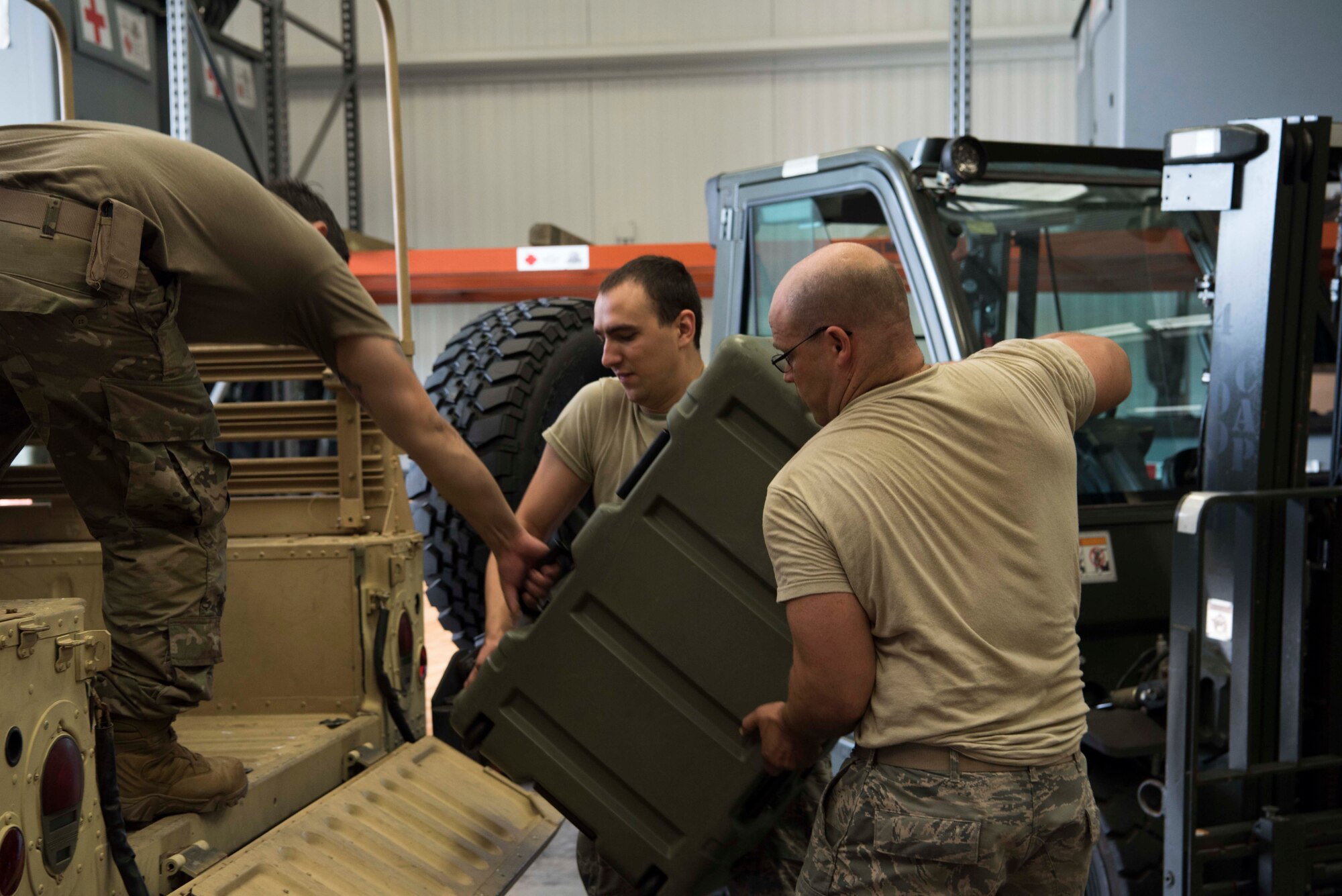 U.S. Air Force Airman 1st Class Benjamin Lippold, a biomedical equipment technician, and Master Sgt. Ursus Vargas, a medical material section chief, both with the 6th Medical Support Squadron (MDSS), load cargo into a Humvee at MacDill Air Force Base, Fla., Sept. 4, 2019. The 6th MDSS was tasked by Air Mobility Command’s chief of Readiness to prepare equipment for use in hurricane relief. (U.S. Air Force Photo by Senior Airman Frank Rohrig)