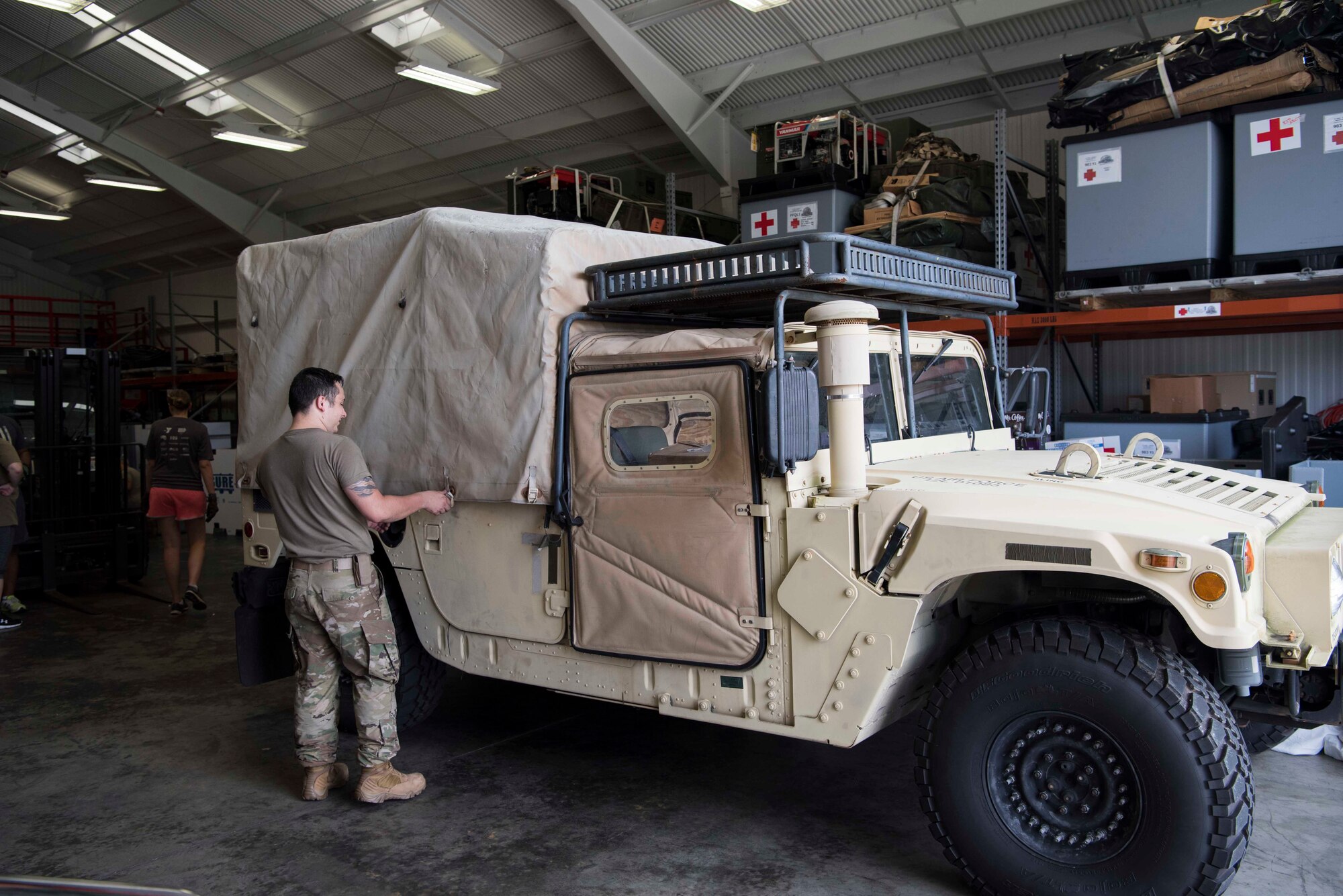 U.S. Air Force Staff Sgt. Dustin Johnson, a 6th Medical Support Squadron (MDSS) biomedical equipment technician, secures the cover of a Humvee at MacDill Air Force Base Fla., Sept. 4, 2019. Air Mobility Command’s Chief of Readiness asked the 6th Medical Support Squadron (MDSS) to prepare equipment for use in hurricane relief. (U.S. Air Force Photo by Senior Airman Frank Rohrig)