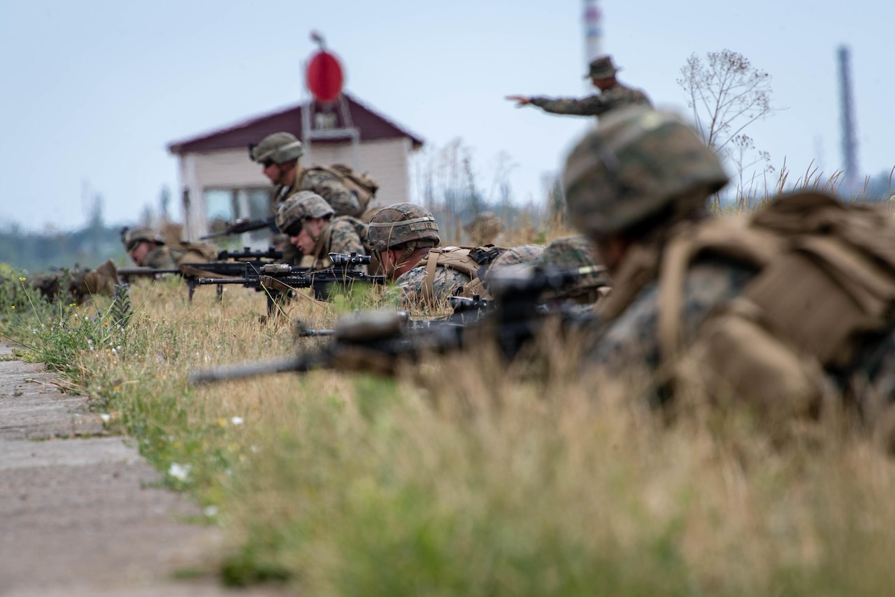 Service members fire weapons