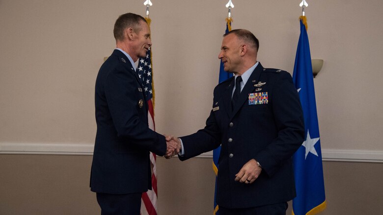 Maj. Gen. James C. Dawkins Jr., left, 8th Air Force and J-GSOC commander, and Col. Matthew W. McDaniel, right, Standoff Munitions Application Center commander, shake hands during an assumption of command ceremony at Barksdale Air Force Base, Louisiana, August 9, 2019. The SMAC is a planning cell designed to bring together the operational planning elements for standoff weapons from the Air Force, Navy, and other services, in order to help better coordinate bomber-launched cruise missiles and air-launched jammers. (U.S. Air Force photo by Airman Jacob B. Wrightsman)