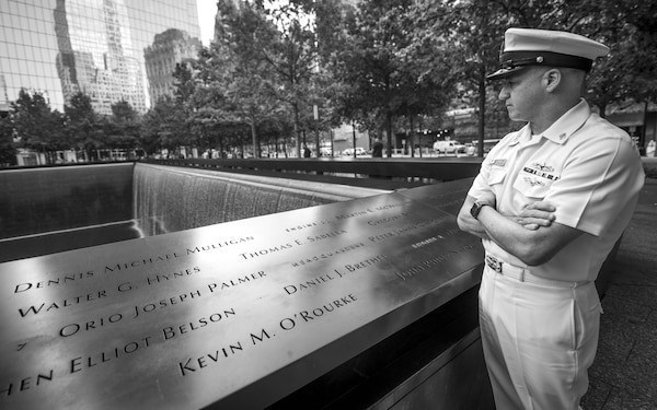 MCPON Looks at names at the 9/11 memorial.