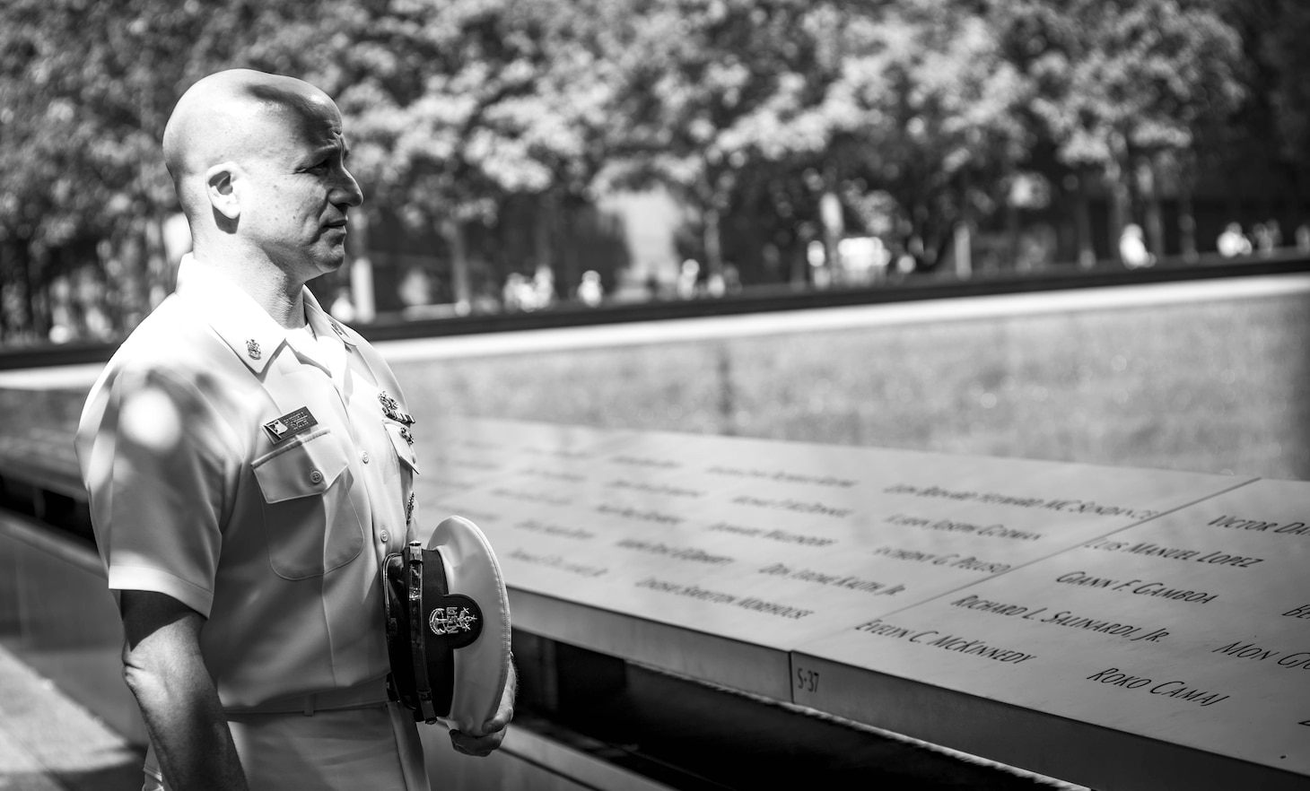 MCPON Looks at names at the 9/11 memorial.