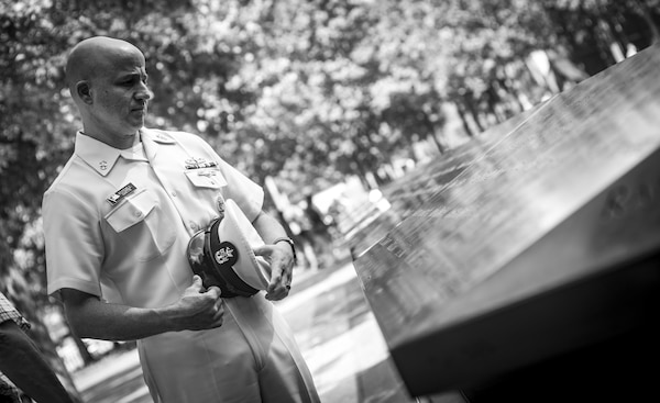 MCPON looks at names at the 9/11 memorial.