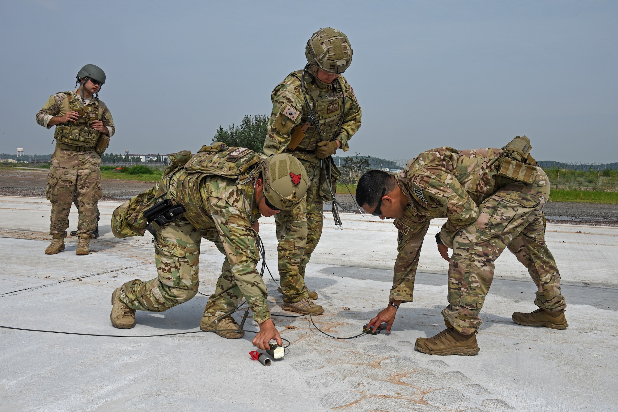 Members of the 8th Civil Engineer Squadron Explosive Ordnance Disposal unit conduct joint ordnance disposal training with the 38th Fighter Group at Kunsan Air Base, Republic of Korea, Aug. 22, 2019. More than 20 Airmen from the two units participated in the joint training, which challenged the EOD units to demonstrate how they would properly dispose of unexploded ordnance in various settings. (U.S. Air Force photo by Staff Sgt. Mackenzie Mendez)