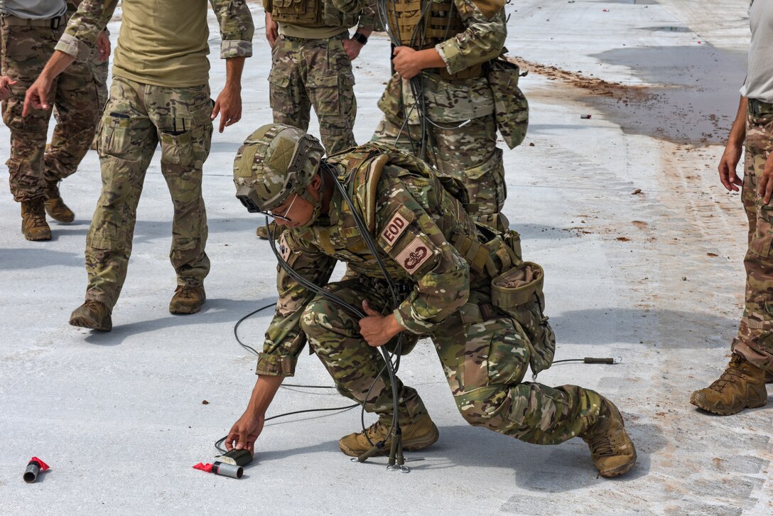 Airmen from the 38th Fighter Group Explosive Ordnance Disposal unit practice disposing of simulated unexploded ordnance during a joint training with the 8th Civil Engineer Squadron EOD unit at Kunsan Air Base, Republic of Korea, Aug. 22, 2019. The 8th CES EOD unit first demonstrated techniques on how to work as one cohesive unit when clearing an area of unexploded ordnance. Following their demonstration, the 38th FG EOD practiced the techniques while receiving assistance and feedback from their American counterparts. (U.S. Air Force photo by Staff Sgt. Mackenzie Mendez)
