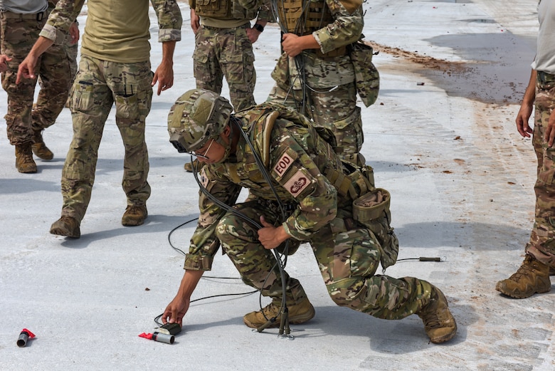 Airmen from the 38th Fighter Group Explosive Ordnance Disposal unit practice disposing of simulated unexploded ordnance during a joint training with the 8th Civil Engineer Squadron EOD unit at Kunsan Air Base, Republic of Korea, Aug. 22, 2019. The 8th CES EOD unit first demonstrated techniques on how to work as one cohesive unit when clearing an area of unexploded ordnance. Following their demonstration, the 38th FG EOD practiced the techniques while receiving assistance and feedback from their American counterparts. (U.S. Air Force photo by Staff Sgt. Mackenzie Mendez)