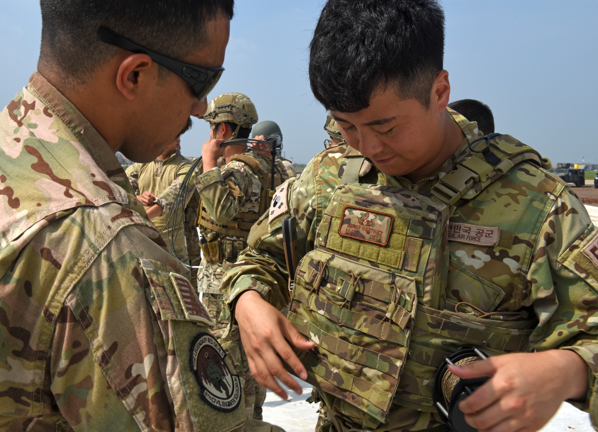 Staff Sgt. Javier Martinez, 8th Civil Engineer Squadron Explosive Ordnance Disposal technician, assists Master Sgt. Myung-Hyung Oh, 38th Fighter Group EOD technician, in putting on individual protective equipment during ordnance disposal training at Kunsan Air Base, Republic of Korea, Aug. 22, 2019. The 8th CES EOD unit partnered with the Republic of Korea Air Force’s 38th FG EOD unit to conduct joint ordnance disposal training, share response procedures and focus on enhancing mission capabilities. (U.S. Air Force photo by Staff Sgt. Mackenzie Mendez)