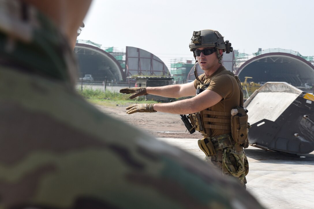 Staff Sgt. Zachary McCarthy, 8th Civil Engineer Squadron Explosive Ordnance Disposal technician, teaches how to properly clear unexploded ordnance during a joint training with the 38th Fighter Group EOD unit at Kunsan Air Base, Aug. 22, 2019. The training gave both the 8th CES and 38th FG EOD units the opportunity to share techniques and practice disposing of ordnance. (U.S. Air Force photo by Staff Sgt. Mackenzie Mendez)
