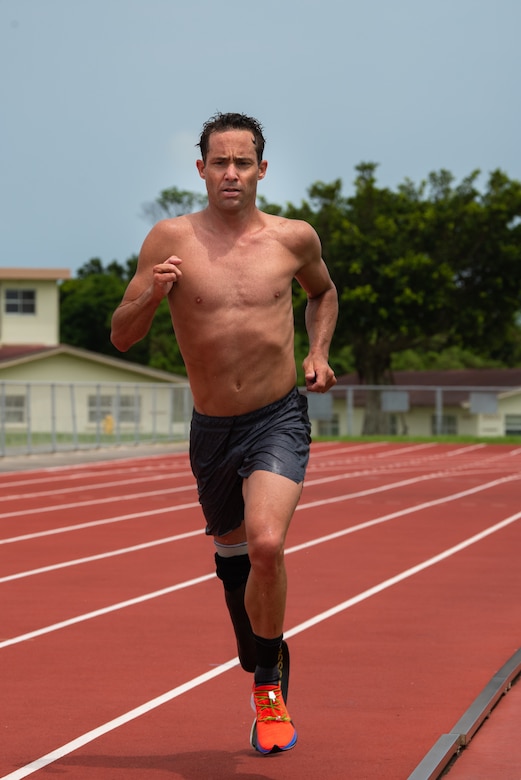 Jamie Brown, U.S. Paratriathlon National Team elite paralympic athlete, runs on the track Aug 12, 2019, on Kadena Air Base, Japan. Brown prepares for the Tokyo 2020 Paralympic Games by sticking to a strict workout regime along his teammates. (U.S. Air Force photo by Senior Airman Cynthia Belío)