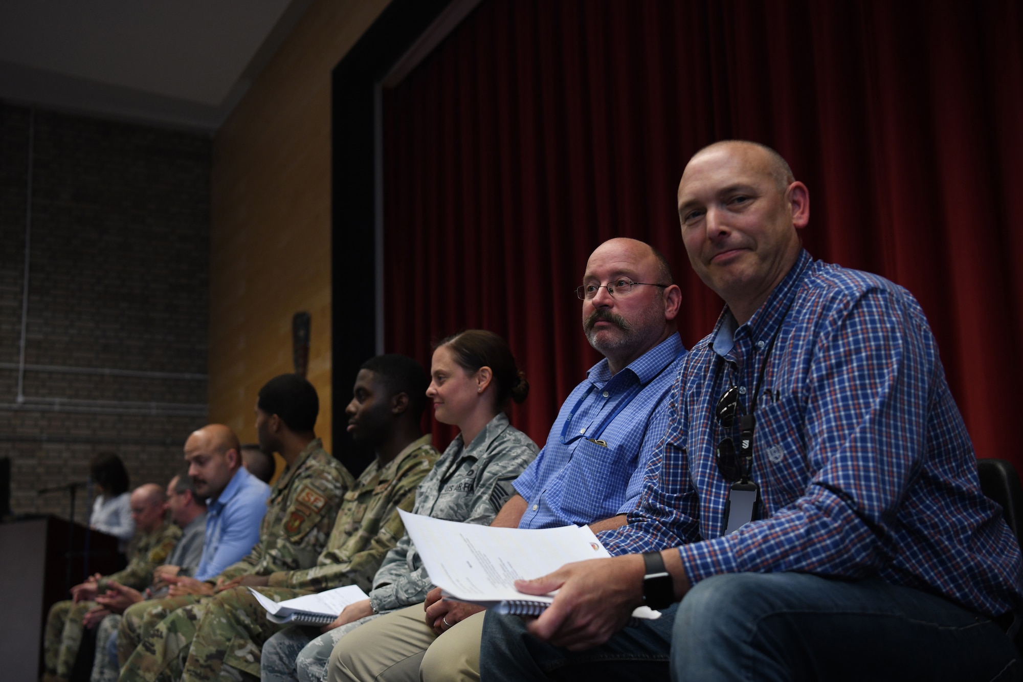 Representatives from the Liberty Wing’s helping agencies prepare to answer questions on a panel during a forum for teachers at Royal Air Force Lakenheath, England, Aug. 29, 2019. Panelist experts provided guidance on matters of available medical services for civilians, health and safety measures for students, agency workshops and base communications. (U.S. Air Force photo by Airman 1st Class Shanice Williams-Jones)