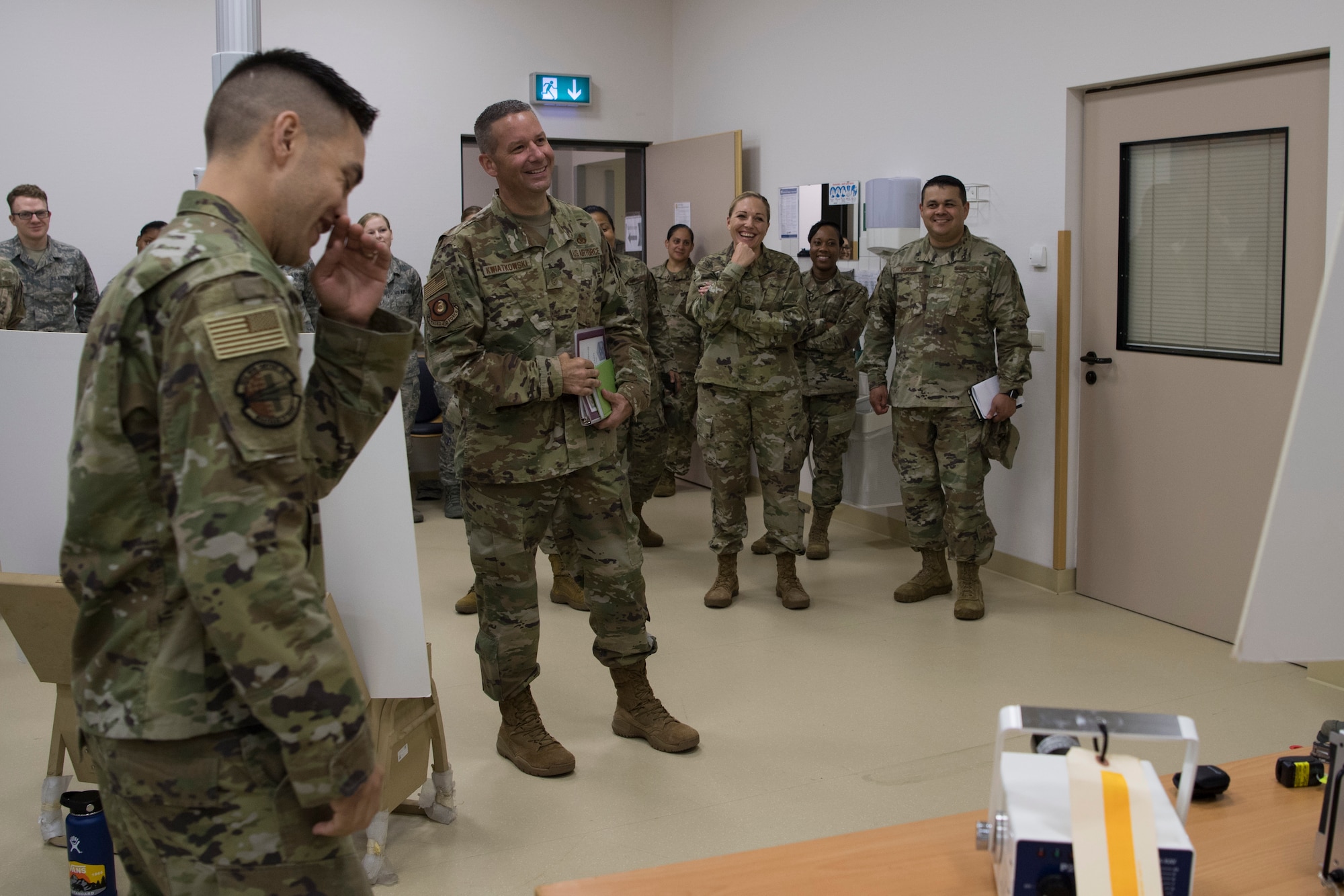 U.S. Air Force Chief Master Sgt. Randy Kwiatkowski, Third Air Force command chief, center, receives a brief from the 86th Medical Support Squadron Airmen on Ramstein Air Base, Germany, July 26, 2019. Kwiatkowski is new to the position and received a day-long tour of operations to better familiarize himself with the mission set of the Kaiserslautern Military Community. (U.S. Air Force photo by Staff Sgt. Nesha Humes Stanton)